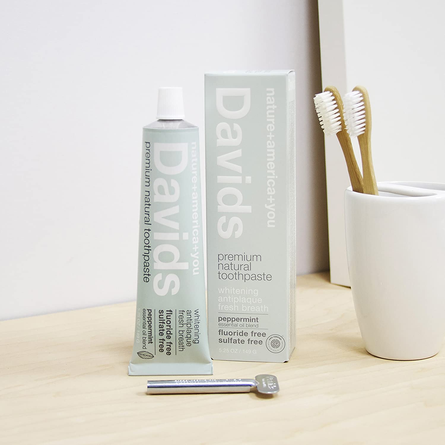 toothbrush and cup with davids natural toothpaste whitening