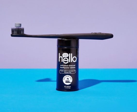 toothbrush on top of hello oral care activated charcoal bottle